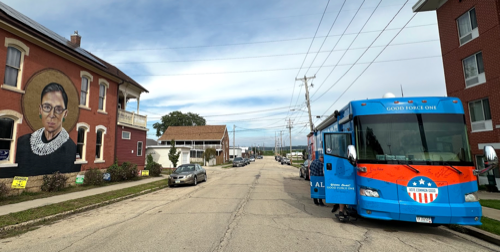 A photo showing the VCG Faith, Hope and Love bus juxtaposed with a mural of Ruth Bader Ginsburg.
